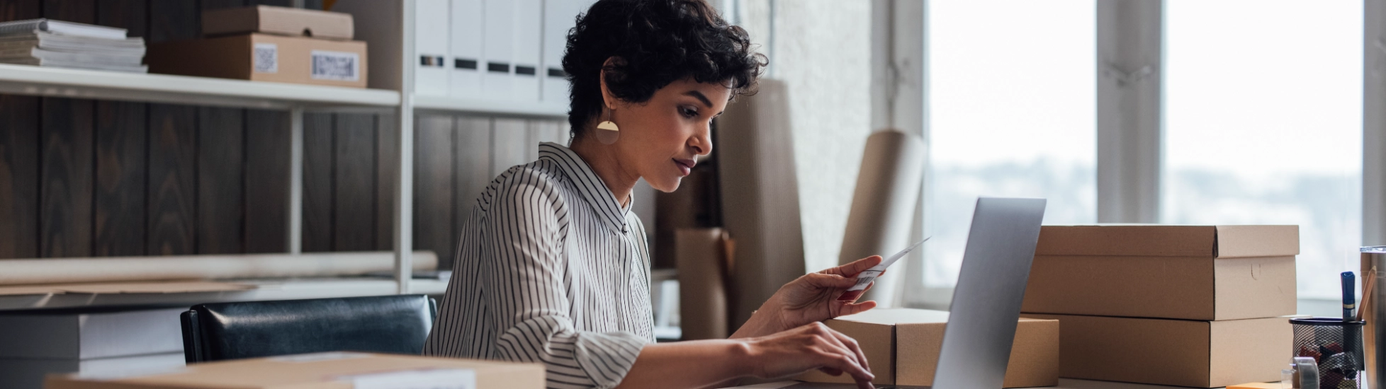 Woman in office surrounded by boxes