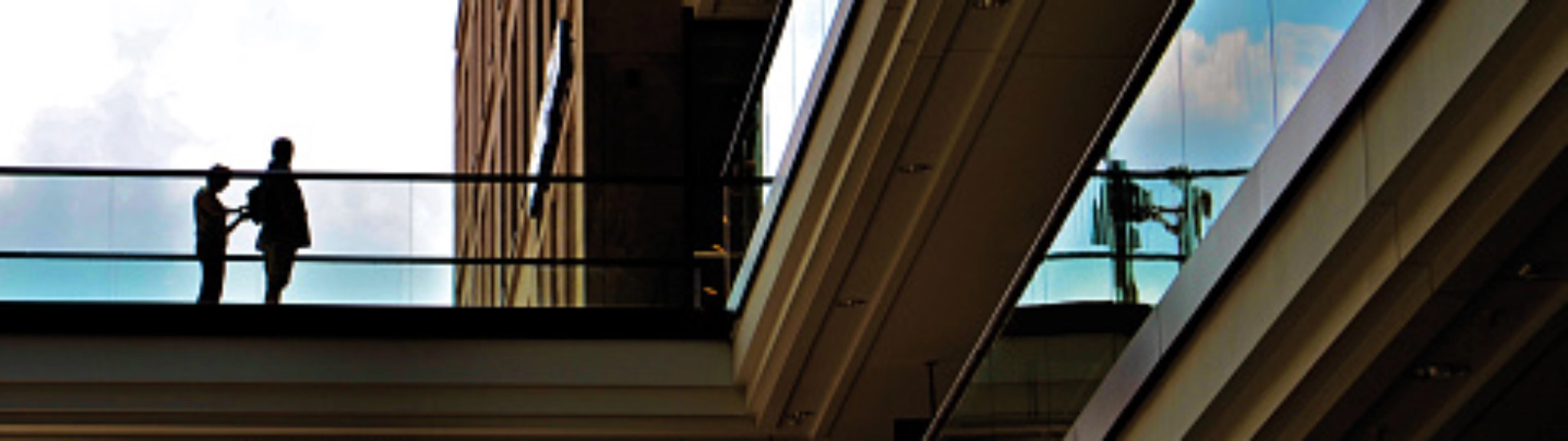 two people standing under an arch of building